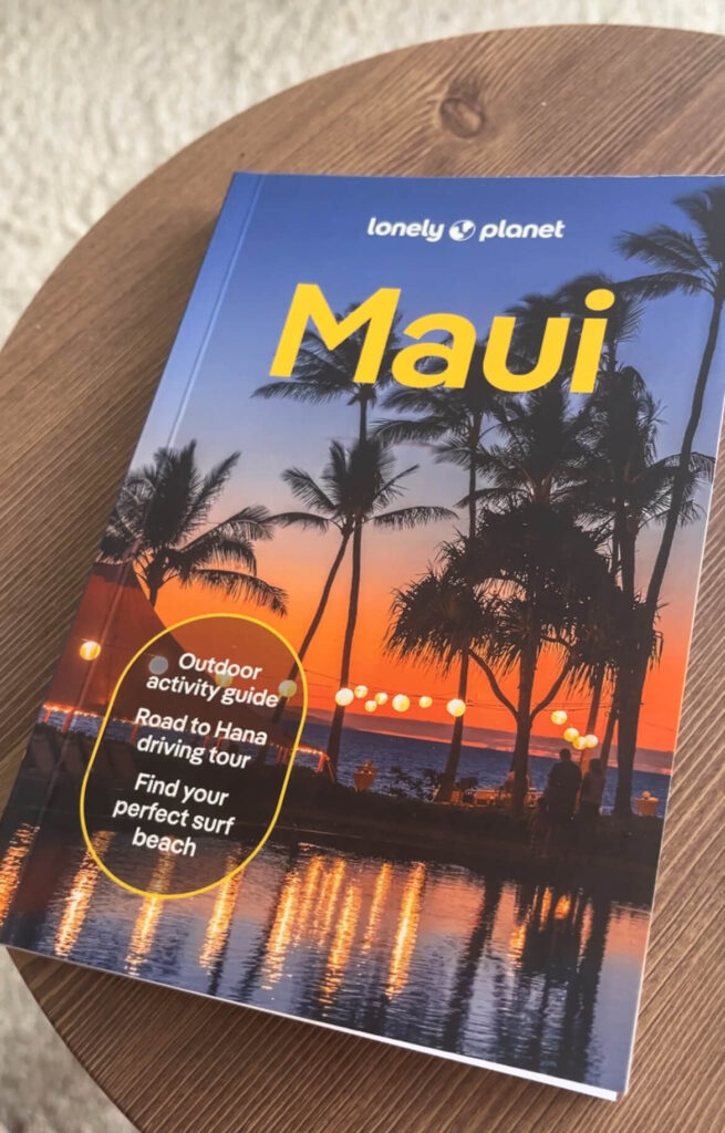 Lonely Planet guidebook cover for Maui. There are palm trees at sunset as the cover image.