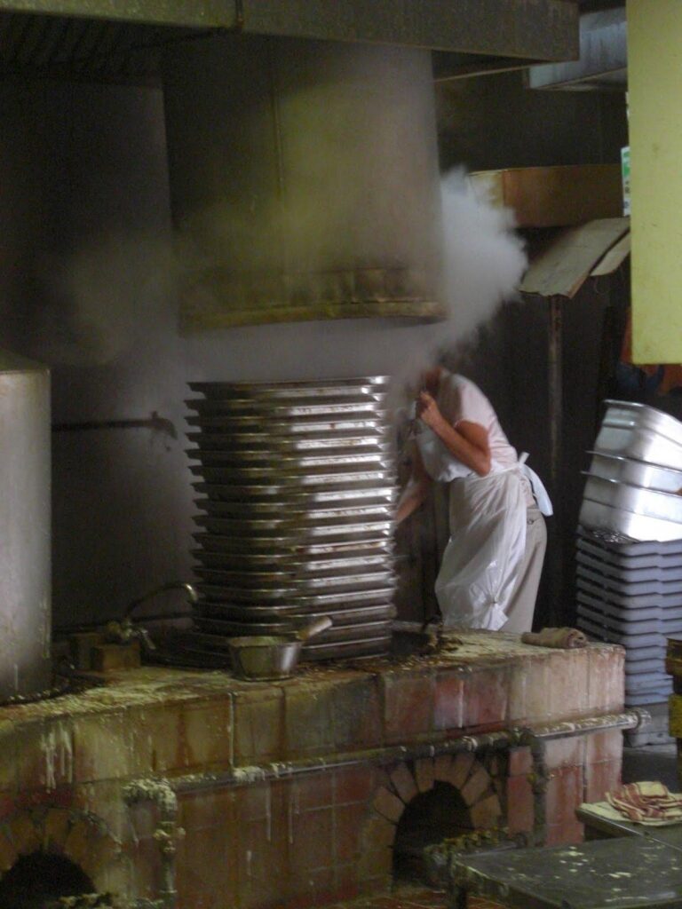 Steaming trays of freshly made look fun noodles at a Chinatown factory in Honolulu, one of the stops on a Hawaii food tour where guests sample local favorites.