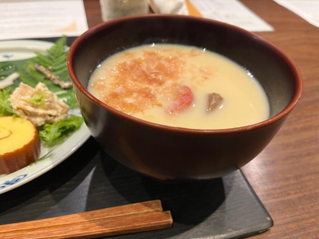 Kansai style ozoni at Choshoku Kishin in Gion, Kyoto. Kansai style includes white miso for a delicate, creamier broth and Kyo-yasai, or Kyoto root vegetables and mochi in the steaming bowl, topped with bonito flakes.